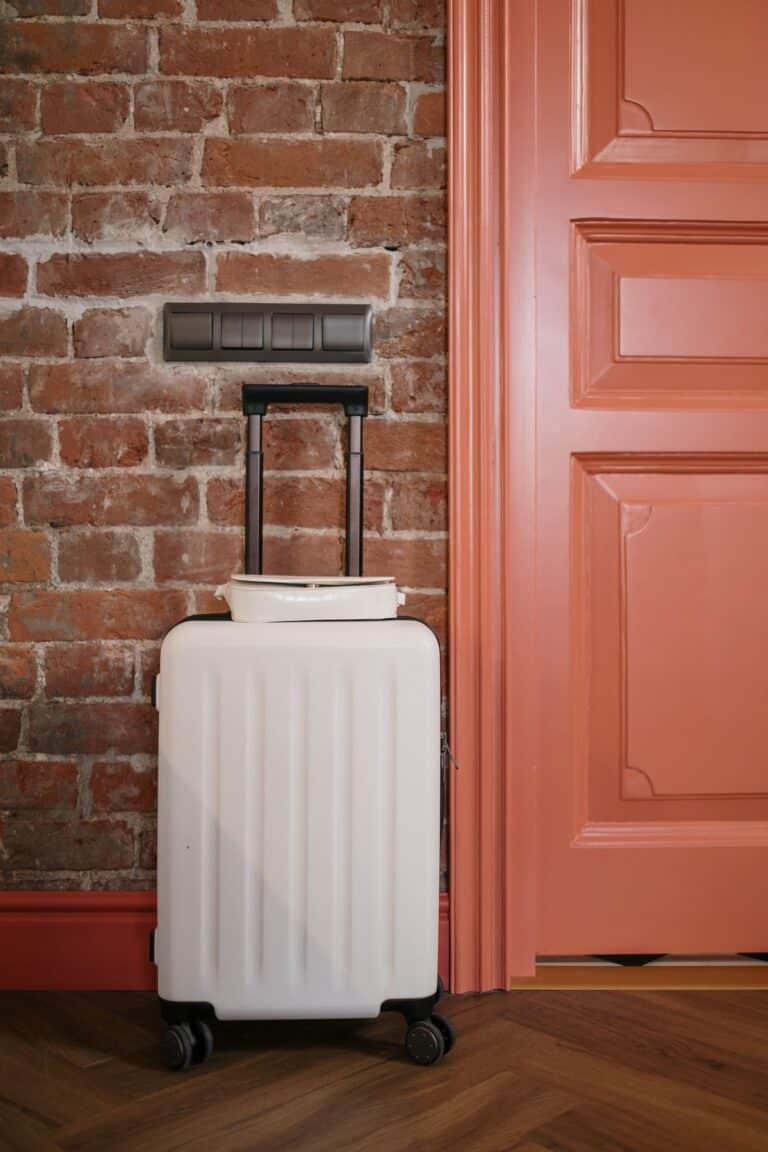 Suitcase by a warm-colored front door on arrival day