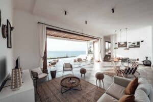 Bright open living room with ocean view through folding doors