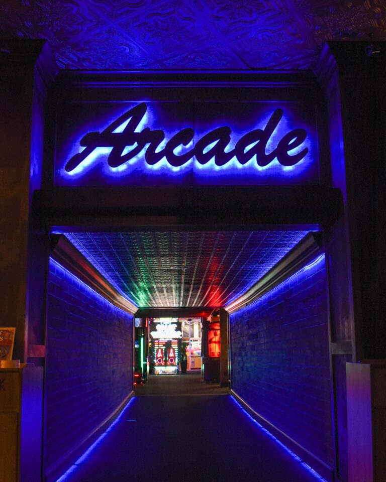 Neon-lit arcade entrance, indoor family fun attraction