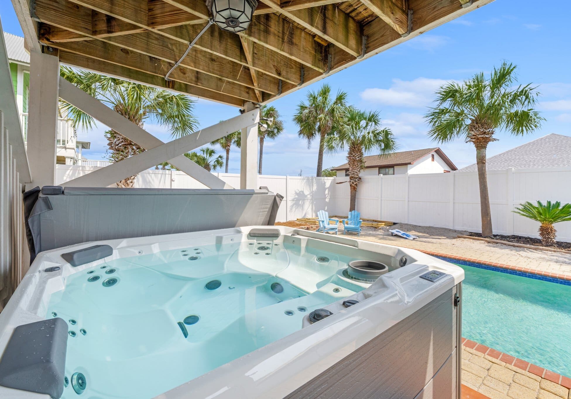 A hot tub in the middle of an outdoor pool.