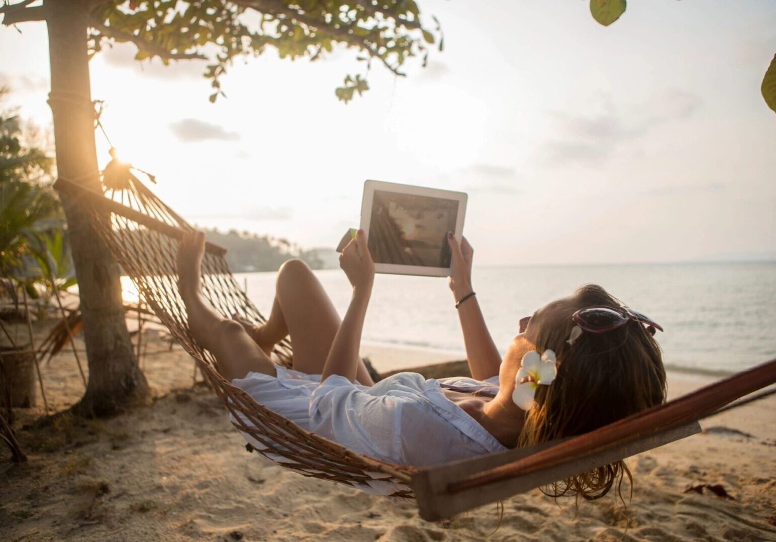 A person laying in the sand on a beach